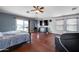 Main bedroom with wood floors and private balcony access at 13616 W San Miguel Ave, Litchfield Park, AZ 85340