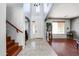 Elegant entryway with high ceilings, hardwood floors, and a view of the staircase at 13616 W San Miguel Ave, Litchfield Park, AZ 85340