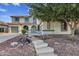 Two-story house with a charming wooden footbridge leading to the entrance at 13616 W San Miguel Ave, Litchfield Park, AZ 85340