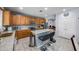 Kitchen with wood cabinets, granite countertops, and a kitchen island at 13616 W San Miguel Ave, Litchfield Park, AZ 85340