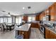 Kitchen features wood cabinets, granite island, and stainless steel appliances at 13616 W San Miguel Ave, Litchfield Park, AZ 85340
