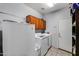 Laundry room with washer, dryer, and storage cabinets at 13616 W San Miguel Ave, Litchfield Park, AZ 85340
