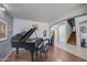 Grand piano in a music room, with views of the entryway and staircase at 13616 W San Miguel Ave, Litchfield Park, AZ 85340