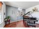 Music room featuring a grand piano and hardwood floors at 13616 W San Miguel Ave, Litchfield Park, AZ 85340