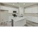 Modern kitchen with white cabinets and spacious island at 13717 S Huntington Rd, Arizona City, AZ 85123