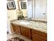 Bathroom with granite countertops, wood cabinets, and a shower at 143 W Michelle Dr, Phoenix, AZ 85023