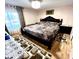 Large bedroom with a king-size bed and wood floors at 143 W Michelle Dr, Phoenix, AZ 85023