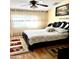Main bedroom with wood floors and a large bed at 143 W Michelle Dr, Phoenix, AZ 85023
