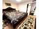 King bedroom with dark wood bed frame and wood floors at 143 W Michelle Dr, Phoenix, AZ 85023