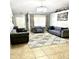 Bright living room with tiled floors, plush sofas, and a chandelier at 143 W Michelle Dr, Phoenix, AZ 85023