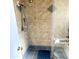 Shower stall with tan tile walls and a built-in seat at 143 W Michelle Dr, Phoenix, AZ 85023