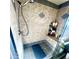 Shower with tan tile, built-in seat, and storage shelf at 143 W Michelle Dr, Phoenix, AZ 85023