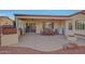 Spacious covered patio with dining area and fire pit at 16486 W Chuparosa Ln, Surprise, AZ 85387