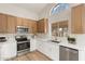 Remodeled kitchen with white cabinets, stainless steel appliances, and quartz countertops at 1651 E Countrywalk Ln, Chandler, AZ 85225