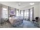 Spacious bedroom with bay window, ceiling fan and neutral decor at 17510 W Glenhaven Dr, Goodyear, AZ 85338