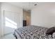 Bedroom with double doors leading to a closet and patterned bedding at 17510 W Glenhaven Dr, Goodyear, AZ 85338