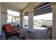 Covered patio with seating area and neighborhood view at 17510 W Glenhaven Dr, Goodyear, AZ 85338