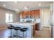 Modern kitchen with wood cabinets and center island at 17510 W Glenhaven Dr, Goodyear, AZ 85338