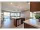Open kitchen with island, stainless steel appliances, and ample counter space at 17510 W Glenhaven Dr, Goodyear, AZ 85338