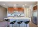 Modern kitchen with wood cabinets and center island at 17510 W Glenhaven Dr, Goodyear, AZ 85338