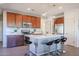 Modern kitchen with wood cabinets and center island at 17510 W Glenhaven Dr, Goodyear, AZ 85338