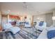 Spacious living room with comfortable seating and a view into the kitchen area at 17510 W Glenhaven Dr, Goodyear, AZ 85338