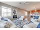 Open concept living room with adjacent kitchen, offering ample space and natural light at 17510 W Glenhaven Dr, Goodyear, AZ 85338