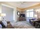 Living room with brown leather furniture and a decorative mirror at 17510 W Glenhaven Dr, Goodyear, AZ 85338