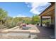 Backyard patio with fire pit and seating area at 17510 W Glenhaven Dr, Goodyear, AZ 85338