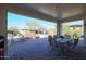 Covered patio with brick pavers and outdoor dining furniture at 17510 W Glenhaven Dr, Goodyear, AZ 85338