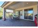 Covered patio with seating area, built-in grill, and paver stones at 17510 W Glenhaven Dr, Goodyear, AZ 85338