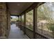 Covered porch with stone flooring and wooden railings at 18514 N 94Th St, Scottsdale, AZ 85255