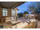 Comfortable patio seating area with built-in grill and string lights at 18514 N 94Th St, Scottsdale, AZ 85255