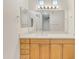 Bathroom features a large mirror, and white vanity top with light wood cabinets at 19777 N 76Th St # 3246, Scottsdale, AZ 85255