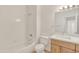 Bathroom features a white toilet, tub shower, and white vanity top with light wood cabinets at 19777 N 76Th St # 3246, Scottsdale, AZ 85255