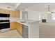 Bright kitchen features stainless steel appliances, light wood cabinetry, and breakfast bar open to living area at 19777 N 76Th St # 3246, Scottsdale, AZ 85255