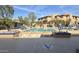 Inviting community pool area with various seating options, greenery, and a view of the buildings at 19777 N 76Th St # 3246, Scottsdale, AZ 85255