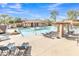 Beautiful community pool with comfortable lounge chairs, tables and umbrellas, and lush landscaping at 19777 N 76Th St # 3246, Scottsdale, AZ 85255