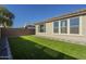 Artificial turf backyard with a view of the home's exterior at 20121 W Lilac St, Buckeye, AZ 85326