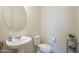 Clean and simple half bathroom with pedestal sink and toilet at 20121 W Lilac St, Buckeye, AZ 85326