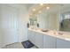 Bright bathroom boasts double sinks, a large mirror, and an adjacent shower at 20121 W Lilac St, Buckeye, AZ 85326