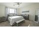 Comfortable bedroom with large windows, ceiling fan, and en-suite bathroom at 20121 W Lilac St, Buckeye, AZ 85326