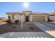 Tan house with tile roof, landscaping, and two-car garage at 20121 W Lilac St, Buckeye, AZ 85326