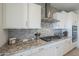 Modern kitchen with gas cooktop and granite countertops at 20121 W Lilac St, Buckeye, AZ 85326