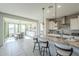 Modern kitchen features granite countertops, stainless steel appliances, and an island with seating at 20121 W Lilac St, Buckeye, AZ 85326