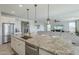 Kitchen island with granite countertop and stainless steel appliances at 20121 W Lilac St, Buckeye, AZ 85326