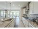 Modern kitchen with granite countertops and white cabinets at 20121 W Lilac St, Buckeye, AZ 85326