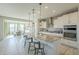 Modern kitchen with island and white cabinets at 20121 W Lilac St, Buckeye, AZ 85326