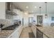 White kitchen with granite countertops and stainless steel appliances at 20121 W Lilac St, Buckeye, AZ 85326