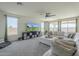 Living room with sectional sofa, large TV, and ceiling fan at 20121 W Lilac St, Buckeye, AZ 85326